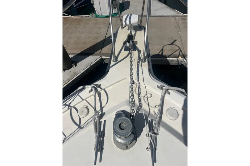 Slide: The Image of Bow of 1989 Egg Harbor 41 Convertible yacht with anchor chain and cleats. - 25