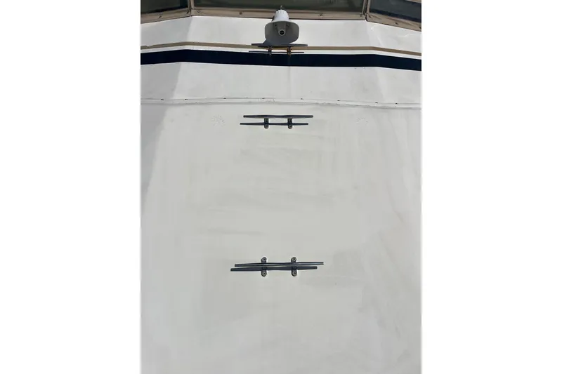 Slide: The Image of 1989 Egg Harbor 41 Convertible boat hull with cleats and a light fixture. - 26