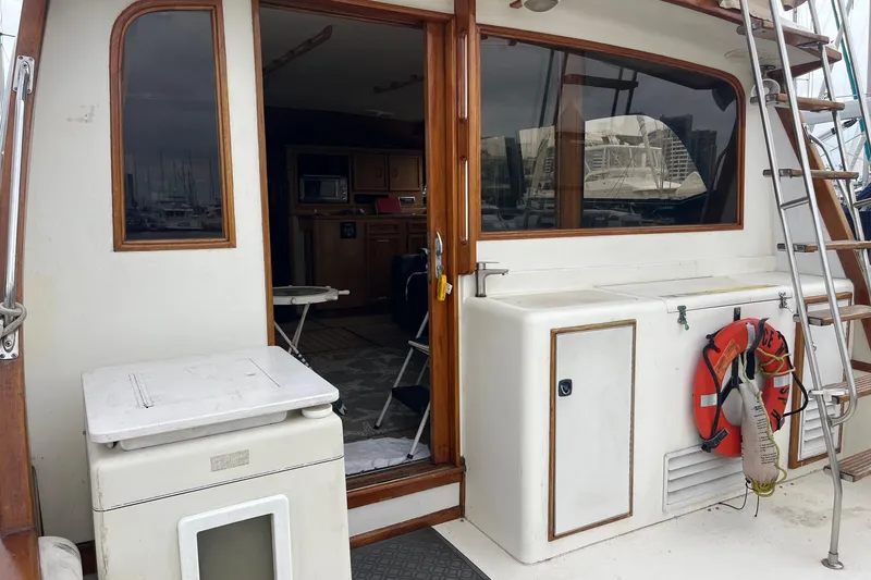 Slide: The Image of 1989 Egg Harbor 41 Convertible yacht interior with wooden accents and safety equipment. - 3