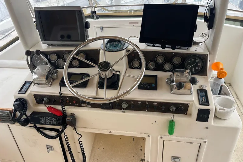 Slide: The Image of 1989 Egg Harbor 41 Convertible boat helm with steering wheel and navigation equipment. - 4