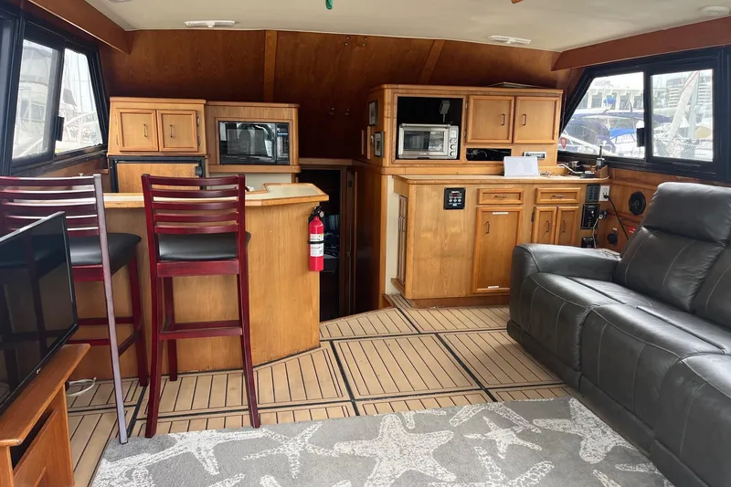 Slide: The Image of Interior of a 1989 Egg Harbor 41 Convertible yacht with wooden cabinetry and seating. - 6