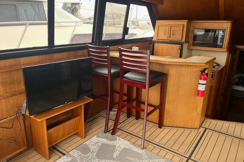 Slide: The Image of Interior of 1989 Egg Harbor 41 Convertible yacht with TV, bar stools, and kitchenette. - 8