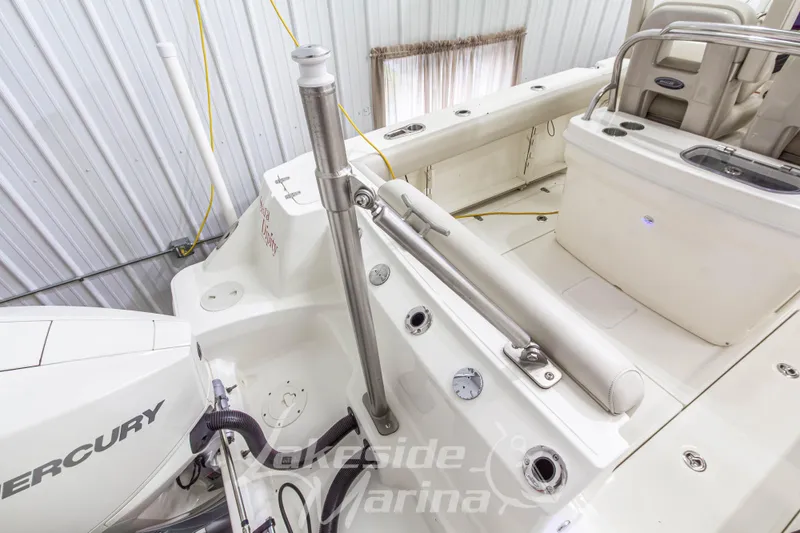 Slide: The Image of 2023 Boston Whaler 250 Outrage boat interior with Mercury engine, showcasing spacious deck layout. - 11