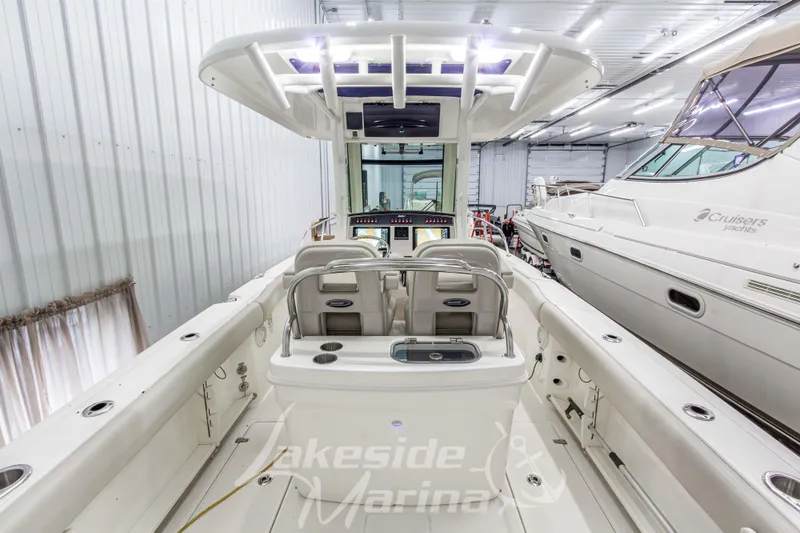Slide: The Image of 2023 Boston Whaler 250 Outrage boat interior in a marina showroom. - 13