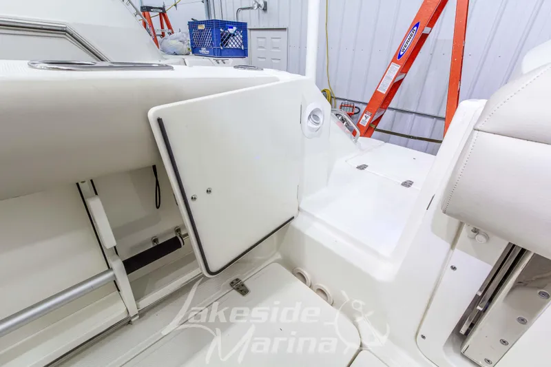 Slide: The Image of 2023 Boston Whaler 250 Outrage interior detail with storage compartment and seating. - 15