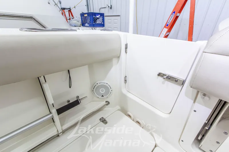 Slide: The Image of Interior view of 2023 Boston Whaler 250 Outrage boat, featuring seating and storage compartments. - 16