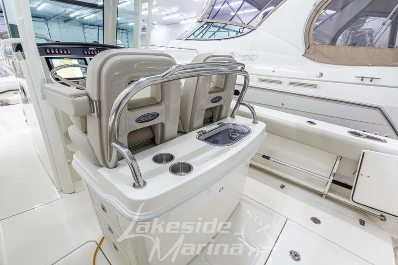 Slide: The Image of 2023 Boston Whaler 250 Outrage interior with helm seats and console, showcased at Lakeside Marina. - 18