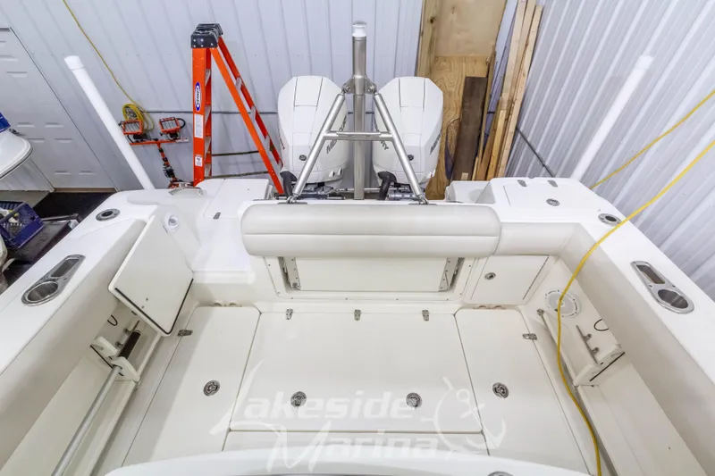 Slide: The Image of 2023 Boston Whaler 250 Outrage boat interior with storage compartments and seating. - 19