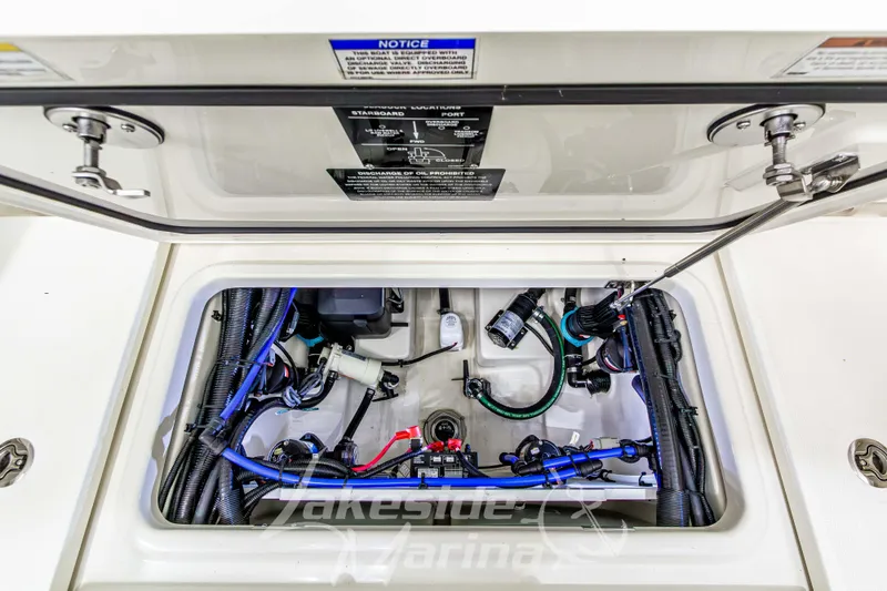 Slide: The Image of 2023 Boston Whaler 250 Outrage boat compartment showcasing wiring and mechanical components. - 22