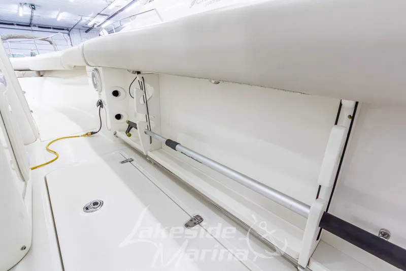 Slide: The Image of 2023 Boston Whaler 250 Outrage interior storage compartment in a well-lit marina. - 23