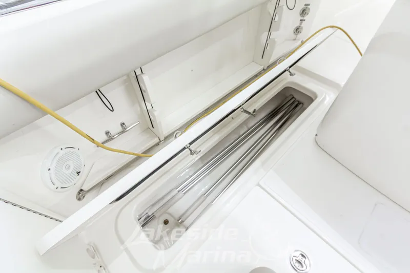 Slide: The Image of 2023 Boston Whaler 250 Outrage boat interior storage compartment with stainless steel rods. - 25