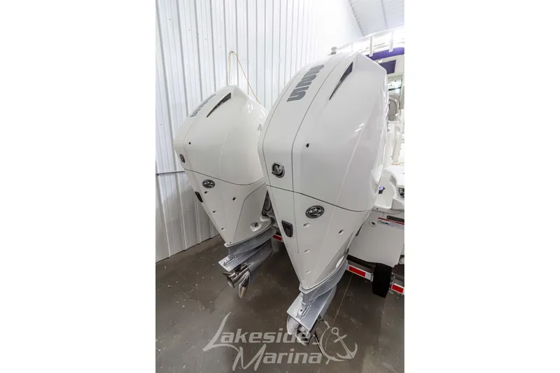 Slide: The Image of Twin outboard engines on a 2023 Boston Whaler 250 Outrage at Lakeside Marina. - 3