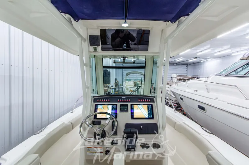 Slide: The Image of Interior view of 2023 Boston Whaler 250 Outrage boat cockpit with navigation screens. - 30