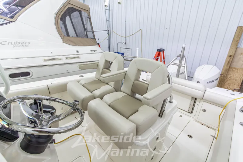 Slide: The Image of 2023 Boston Whaler 250 Outrage boat interior with dual helm seats and steering wheel. - 32