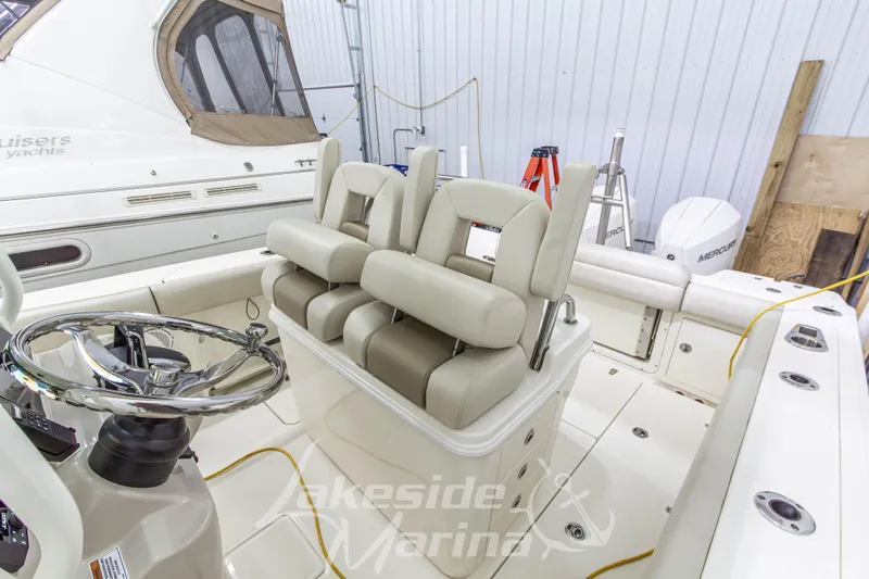 Slide: The Image of 2023 Boston Whaler 250 Outrage boat interior with steering wheel and seating. - 33