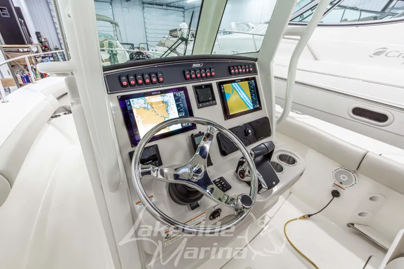 Slide: The Image of 2023 Boston Whaler 250 Outrage helm with advanced navigation displays and controls. - 34