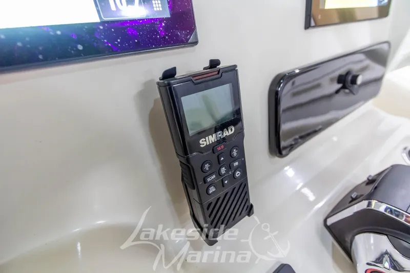 Slide: The Image of Simrad marine radio on 2023 Boston Whaler 250 Outrage dashboard, featuring modern navigation technology. - 38