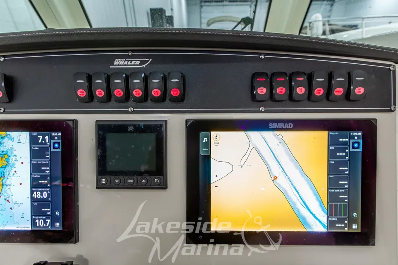 Slide: The Image of Boston Whaler 250 Outrage 2023 dashboard with navigation and control panels. - 39