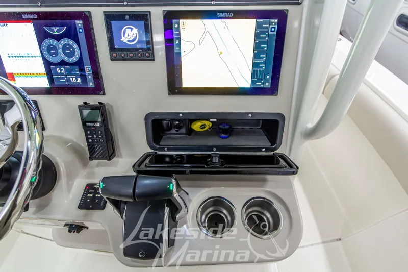 Slide: The Image of Control panel of 2023 Boston Whaler 250 Outrage with Simrad displays and throttle controls. - 40