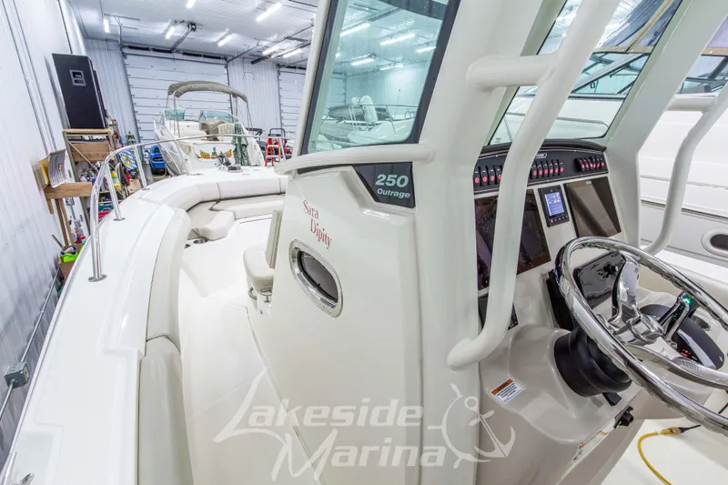 Slide: The Image of 2023 Boston Whaler 250 Outrage boat interior in a marina storage facility. - 45