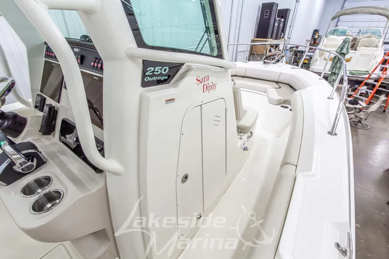 Slide: The Image of 2023 Boston Whaler 250 Outrage boat interior with helm and seating area. - 46