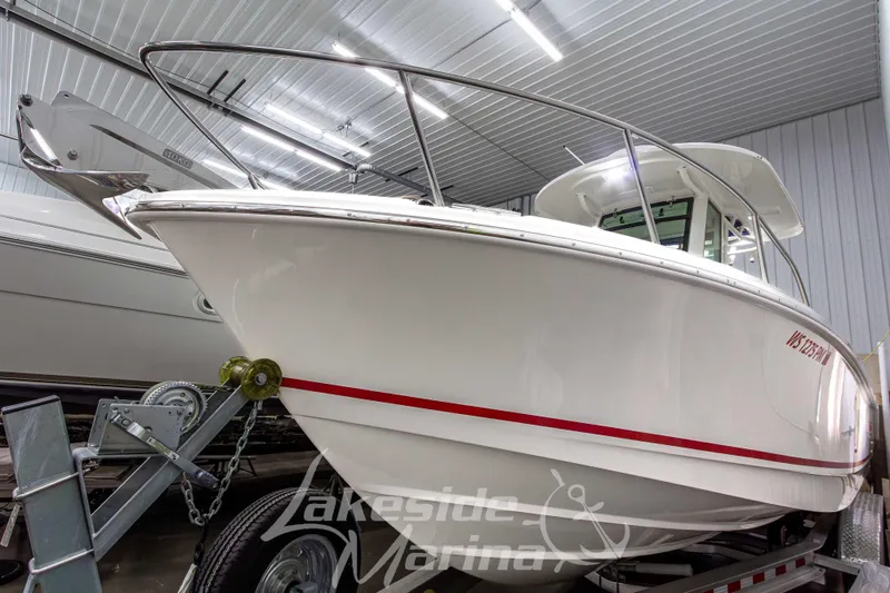 Slide: The Image of 2023 Boston Whaler 250 Outrage boat in indoor marina setting. - 5