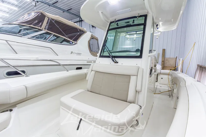 Slide: The Image of 2023 Boston Whaler 250 Outrage boat interior with seating, stored indoors. - 51
