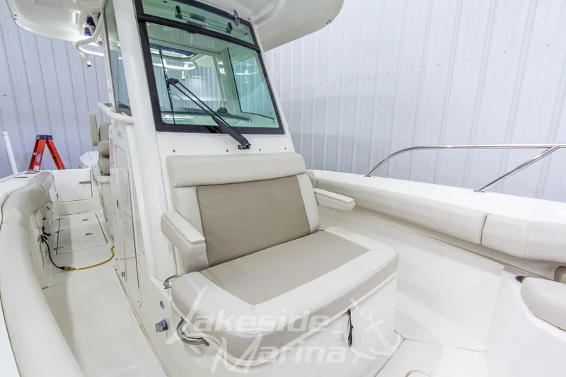 Slide: The Image of 2023 Boston Whaler 250 Outrage interior with seating and helm, showcased indoors. - 52