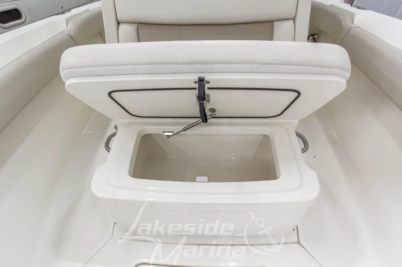 Slide: The Image of 2023 Boston Whaler 250 Outrage boat seat with storage compartment open. - 53