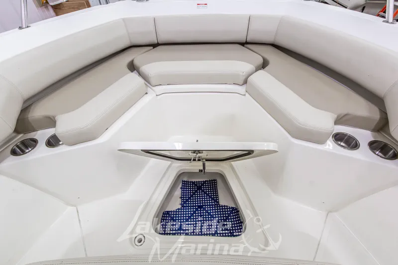 Slide: The Image of 2023 Boston Whaler 250 Outrage boat interior with cushioned seating and storage compartment. - 55