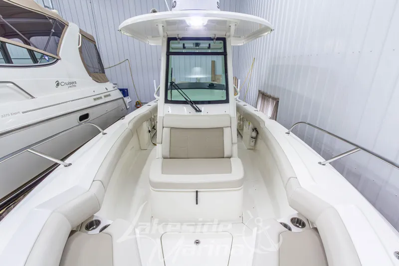 Slide: The Image of 2023 Boston Whaler 250 Outrage boat interior with seating, stored indoors. - 60