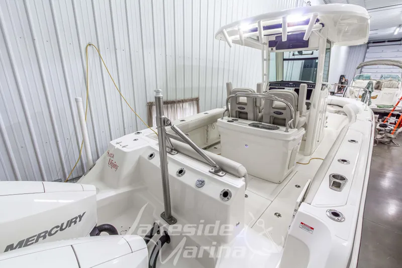 Slide: The Image of 2023 Boston Whaler 250 Outrage boat interior with Mercury engines in a marina. - 7