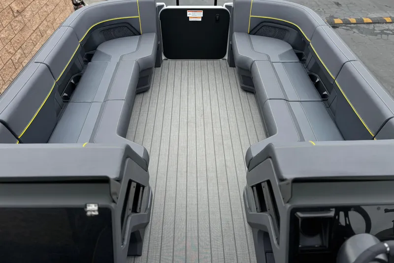 Slide: The Image of 2025 Manitou EXPLORE 24 boat interior with sleek gray seating and modern design. - 10