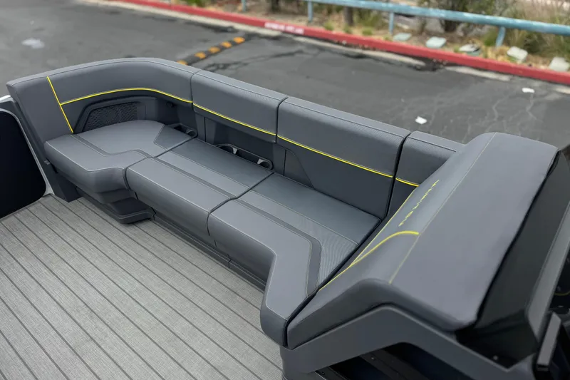 Slide: The Image of 2025 Manitou EXPLORE 24 boat seating with sleek gray upholstery and yellow accents. - 12