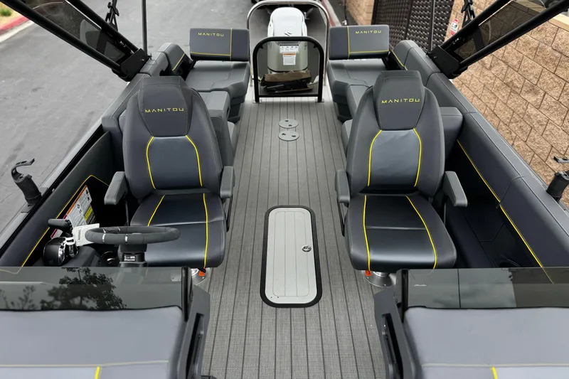 Slide: The Image of 2025 Manitou EXPLORE 24 boat interior with sleek seating and modern design. - 13