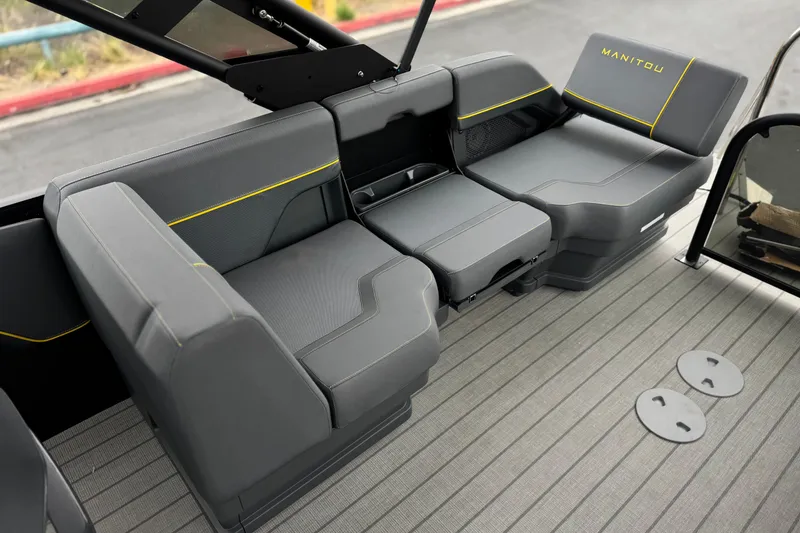 Slide: The Image of Luxurious seating in the 2025 Manitou EXPLORE 24 boat, featuring sleek gray upholstery. - 15