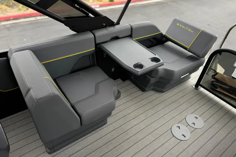 Slide: The Image of Luxurious seating area of 2025 Manitou EXPLORE 24 boat with modern design and cup holders. - 17