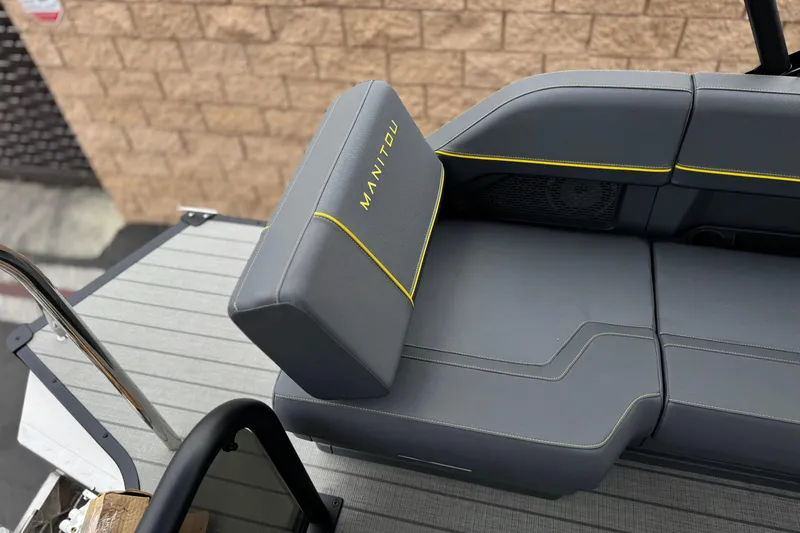 Slide: The Image of 2025 Manitou EXPLORE 24 boat seat with gray upholstery and yellow accents. - 19
