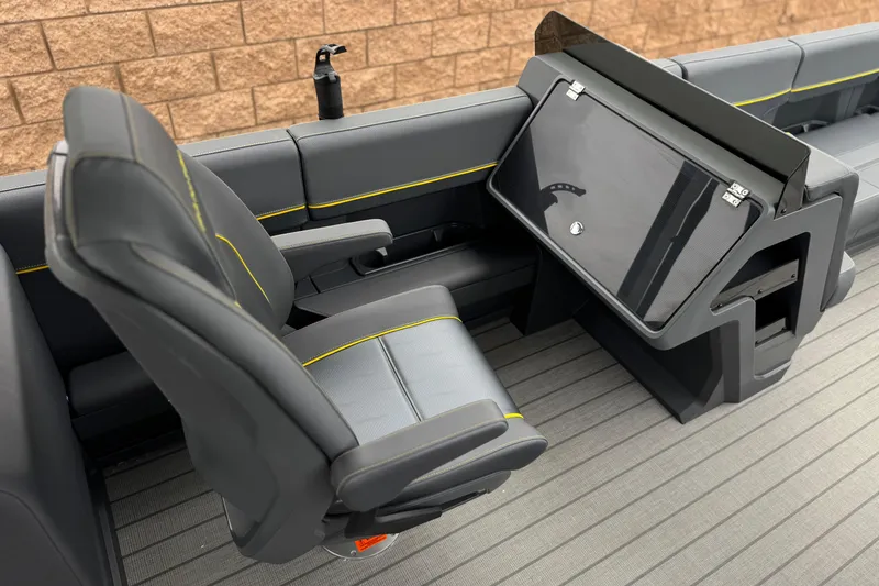 Slide: The Image of 2025 Manitou EXPLORE 24 boat interior with sleek seating and modern dashboard design. - 22