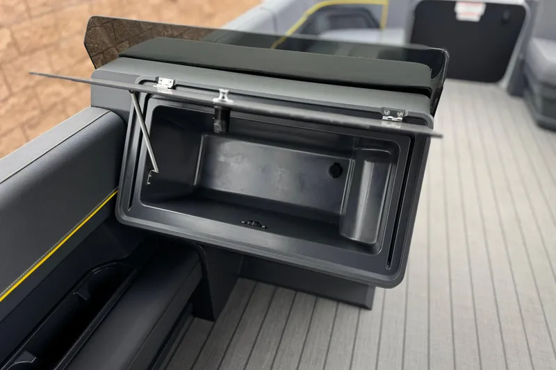Slide: The Image of Open storage compartment on 2025 Manitou EXPLORE 24 boat, featuring sleek interior design. - 23