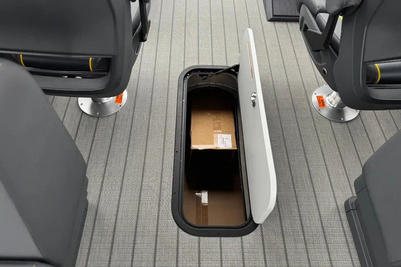 Slide: The Image of Underfloor storage compartment in 2025 Manitou EXPLORE 24 boat, featuring secure storage space. - 24