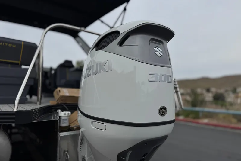 Slide: The Image of Outboard motor on 2025 Manitou EXPLORE 24 boat, featuring Suzuki 300 engine. - 8