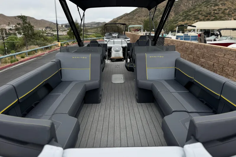 Slide: The Image of 2025 Manitou EXPLORE 24 pontoon boat interior with sleek seating and modern design. - 9