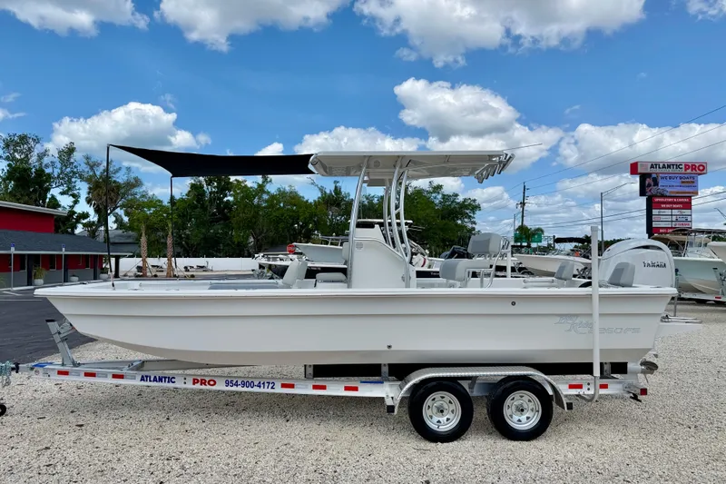 The Image of 2027 Bay Rider 2260 FS Skiff on trailer, displayed outdoors under blue sky. - 0
