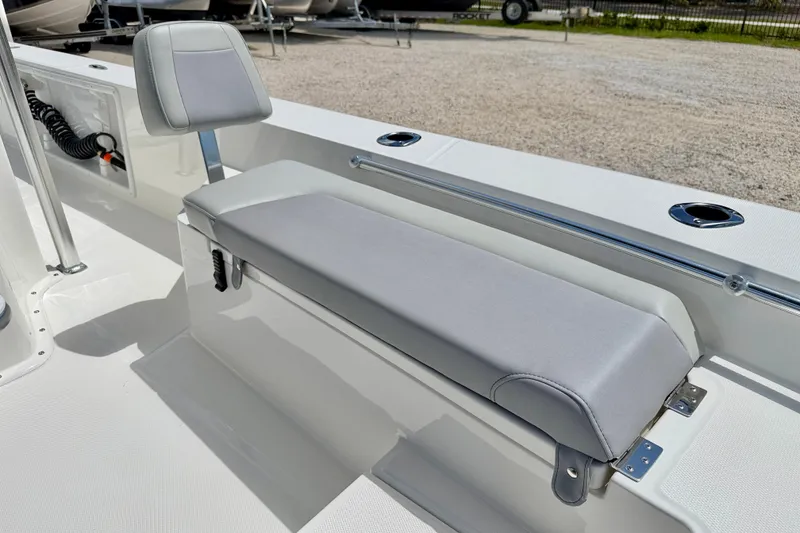 Slide: The Image of Bay Rider 2260 FS Skiff 2027 interior with cushioned seating and storage compartment. - 12