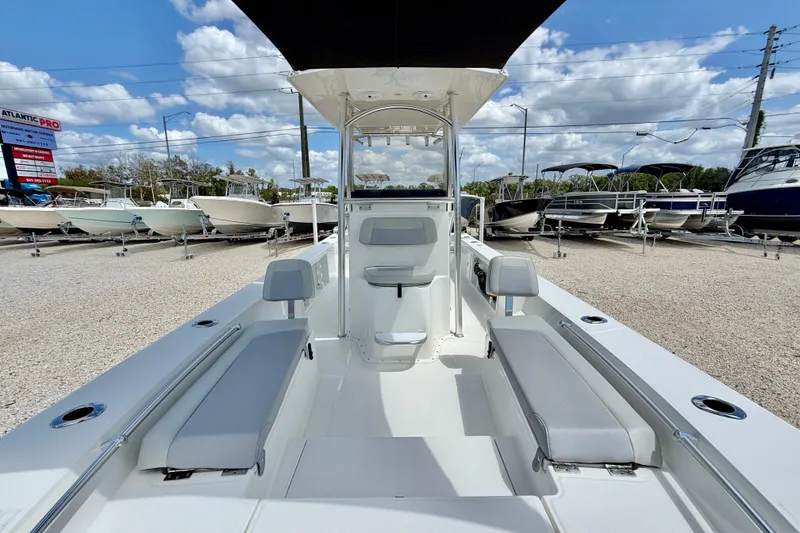 Slide: The Image of Bay Rider 2260 FS Skiff 2027 model, featuring spacious seating and sleek design at a boat dealership. - 15
