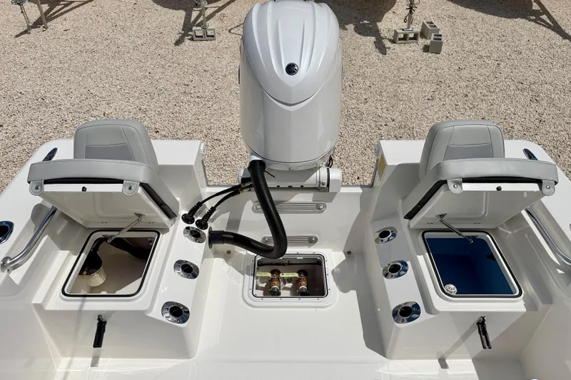 Slide: The Image of Bay Rider 2260 FS Skiff 2027 boat interior with open storage compartments and engine. - 34