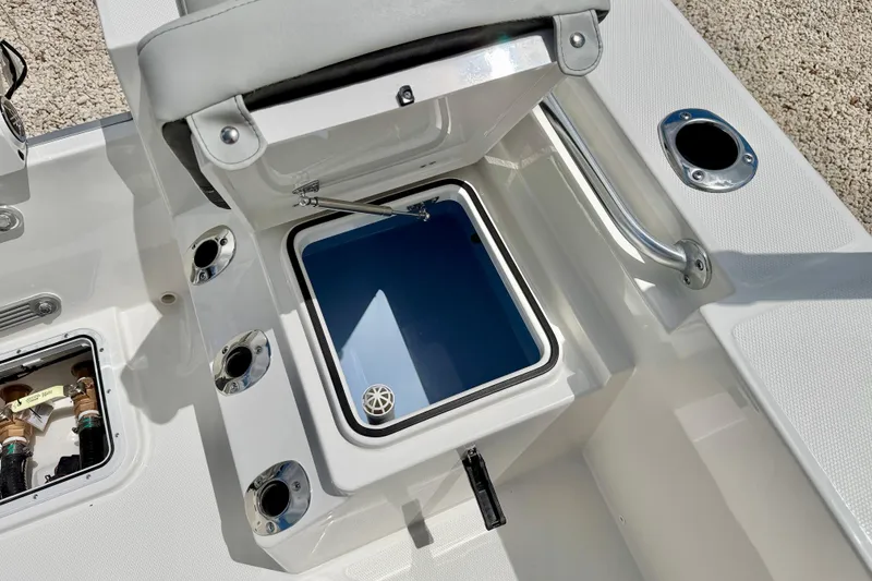 Slide: The Image of 2027 Bay Rider 2260 FS Skiff interior with open storage compartment and rod holders. - 36