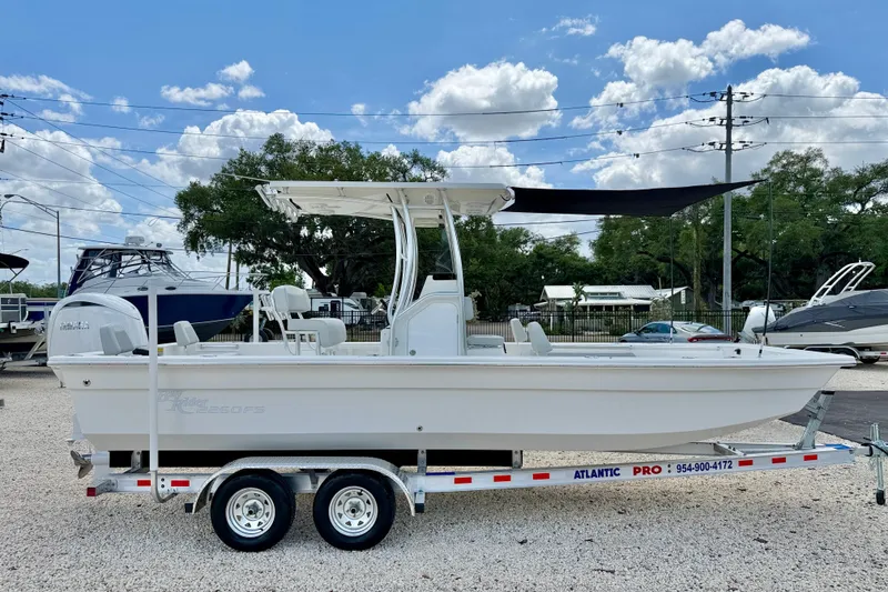 Slide: The Image of 2027 Bay Rider 2260 FS Skiff on trailer, displayed outdoors under blue sky. - 4