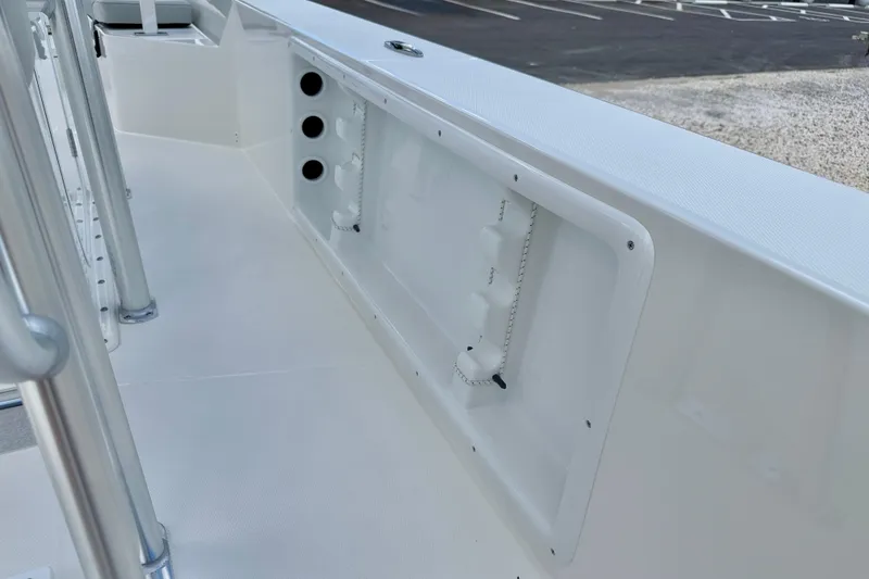 Slide: The Image of Bay Rider 2260 FS Skiff 2027 interior detail, featuring rod holders and storage compartments. - 41